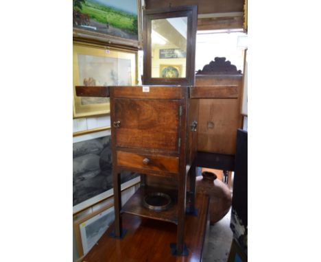 A George III mahogany gentleman's washstand, the hinged top enclosing a rising mirror, 38.5cm wide.    Condition Report:  Som