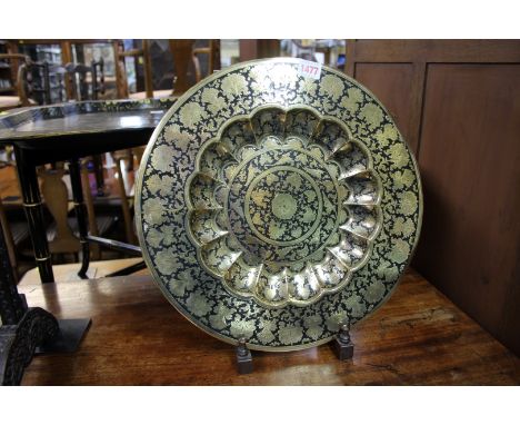 An Indian brass and coloured enamel dish, 39cm diameter, on mahogany easel stand. 