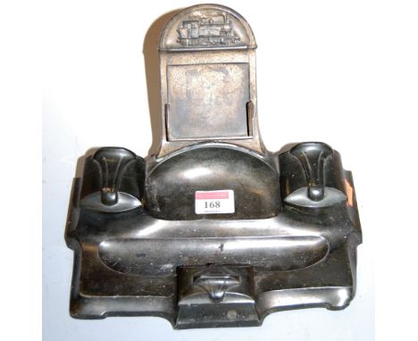 An Art Nouveau brass desk stand with twin inkwells and stamp holder below