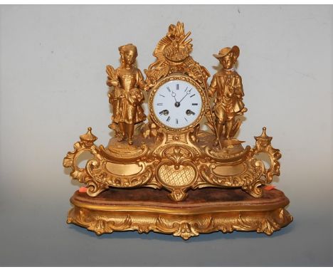 A late 19th century French gilt metal cased mantel clock, having enamelled dial with Roman numerals and eight day movement, t