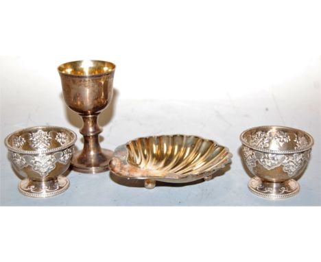 A pair of Victorian silver egg-cups, having embossed Celtic style and mask decoration, with gilt-washed interior and beaded r