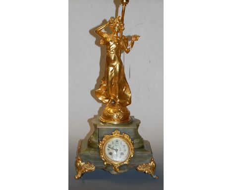 A 19th century French onyx and gilt metal mounted mantel clock having a painted enamel dial with Roman numerals and eight day
