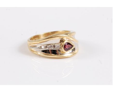An 18ct ruby and white hardstone ring, the pear shaped ruby, collet mounted within a tapering crossover panel of white gold s