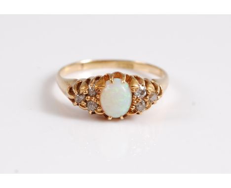 An 18ct opal and diamond ring, the oval opal cabochon, set to either side with mixed cut diamonds, total weight of diamonds e