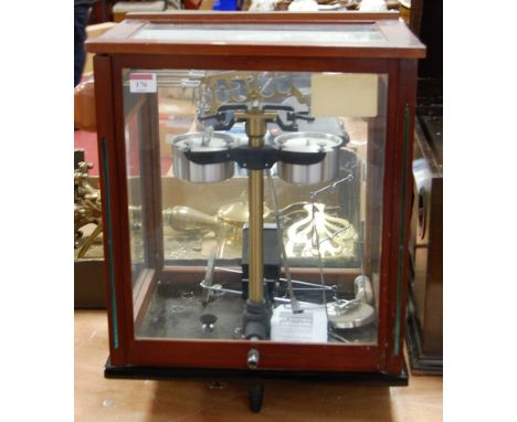 A set of laboratory scales in glazed mahogany case, bearing a label for Sartorius Werke, Gottingen, model DP3/200G, width 39c