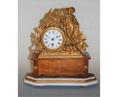 A late 19th century French gilt metal cased mantel clock, having enamelled dial with Roman numerals, the whole surmounted by 