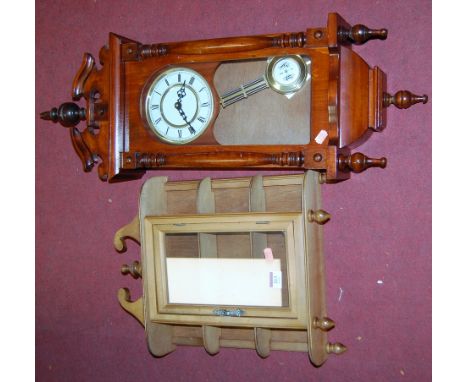 A reproduction mahogany cased wall clock; together with a modern glazed beech hanging wall cabinet