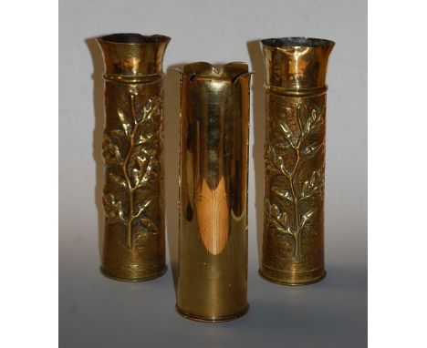 A pair of World War One trench art shell case vases, each having embossed oak leaf and acorn decoration, h.30cm; together wit