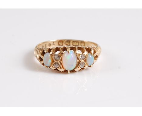 An 18ct three stone opal ring, the three oval graduated opals, interspaced with diamond highlights, with tapered ridged shoul