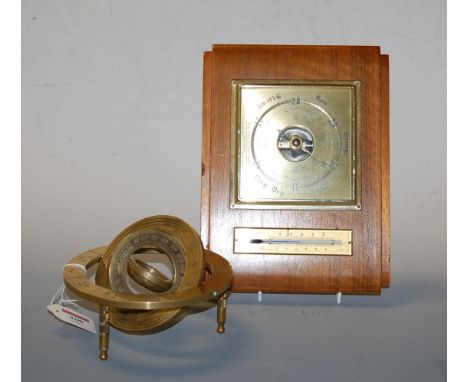 A modern brass table top compass the outer scale engraved with signs of the zodiac, together with an Art Deco walnut cased ba