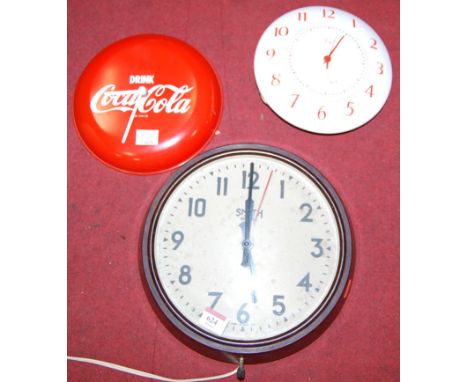 A mid century enamelled Smiths electric clock together with a bakelite Smiths clock, and a Coca Cola advertising clock