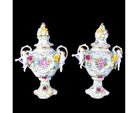 Pair Vintage Dresden Style Porcelain Covered Urns. Each hand painted and decorated with applied flowers, putti figures. Signe