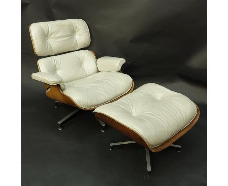 Herman Miller Eames Lounge Chair With Ottoman. Beige leather and rosewood. Measures 30-1/2" H x 32-3/4" W x 21-1/2" D. Ottoma