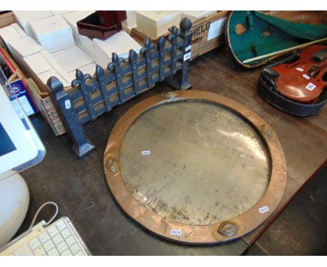 An Arts and crafts circular Copper frame and a Iron fire grate front