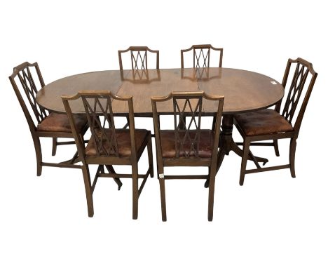 Regency design mahogany twin pillar dining table, oval top with brass inlaid stringing and reeded edge, on sabre tripod bases