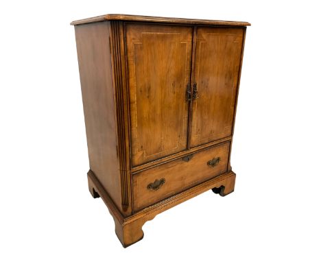 Georgian design yew wood enclosed cabinet, two doors enclosing slide over fall front false drawer, on bracket feetDimensions: