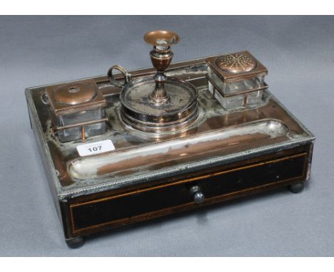 Georgian desk inkstand, the top with silver plate on copper candlestick, pounce pot, inkwell and pen tray over a  mahogany ba