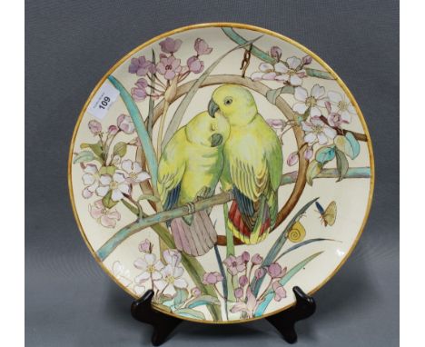 Mintons Art Pottery Studio Kensington Gore charger, painted with two birds on a perch amongst blossom, date code for 1882 and