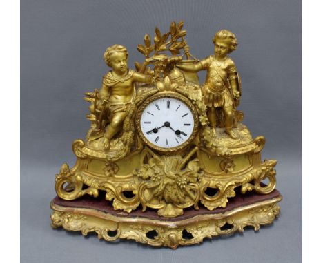 French gilt metal figural mantle clock, with a circular dial with roman numerals within a classical case surmounted by Mars &
