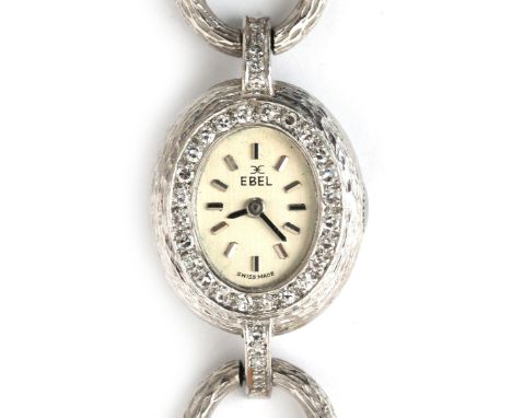 An 18 karat white gold Ebel lady's wristwatch, ca. 1980. Manual wind, cal. 52. An oval case, silver tone dial with batons to 