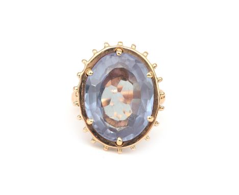 A 18 karat gold sapphire ring, ca. 1950. Featuring a light blue oval faceted cut ' colour change' sapphire (probably syntheti