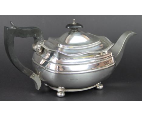 A silver teapot, W & C Sissons, Sheffield 1928, of low rectangular form, gadrooned rim and raised on four bun feet, ebonised 