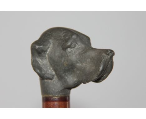 A walking stick with dogs head terminal