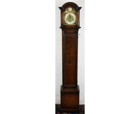 A 1920's oak grandmother clock, silvered Roman numeral chapter ring and movement striking on six gongs, back plate initialled
