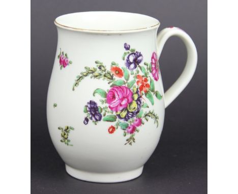 An 18th century first period Worcester porcelain baluster mug, painted with floral bouquets and sprigs, (crack to handle), 12