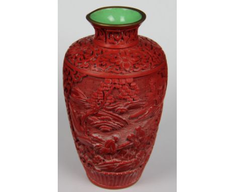 A Chinese cinnabar lacquer vase, decorated with figures in a garden, green enamel interior, 15cm