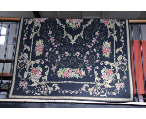 A French tapestry carpet, decorated with an all over foliate design against a black ground, 228cm x 154cm