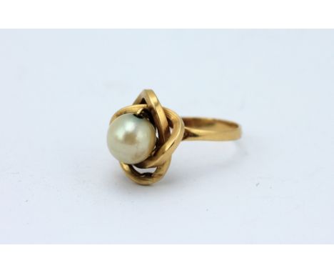 A cultured pearl set dress ring, designed as a central pearl (7mm diameter) within decorative yellow metal surround, weight 3