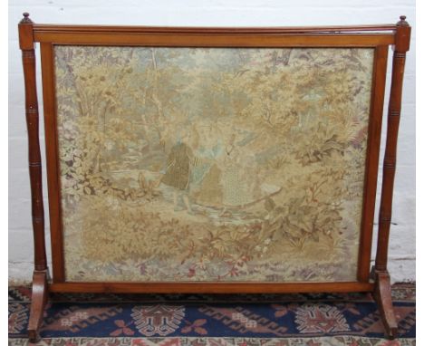 An early Victorian mahogany fire screen, inset with a silk work picture depicting three figures crossing a woodland stream, 7