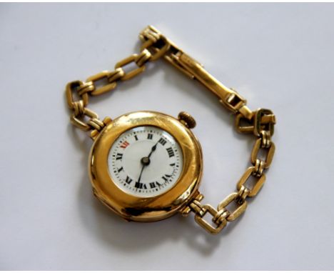 A lady's 9ct yellow gold wristwatch 'Swiss Made', circular white enamel dial with Roman numerals and attached gold decorative