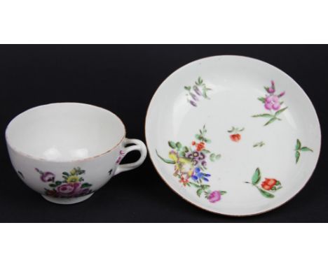 An 18th century Worcester porcelain tea cup and saucer, Dr Wall period, moulded entwined sprig handle and painted with floral