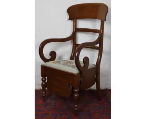 A Victorian mahogany commode chair, with tapestry seat on turned legs