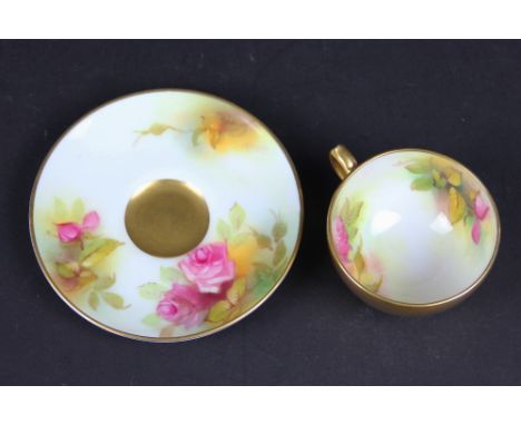 A Royal Worcester demitasse cup and saucer, painted with flowers by M Hunt, dated code for 1932 (2)