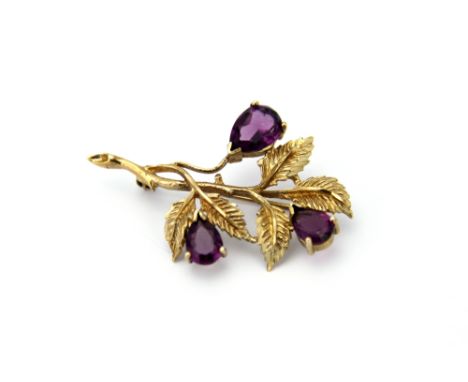 An amethyst set spray brooch in 9ct yellow gold, the three pear shaped amethysts within 9ct gold foliate surround, weight 5.5