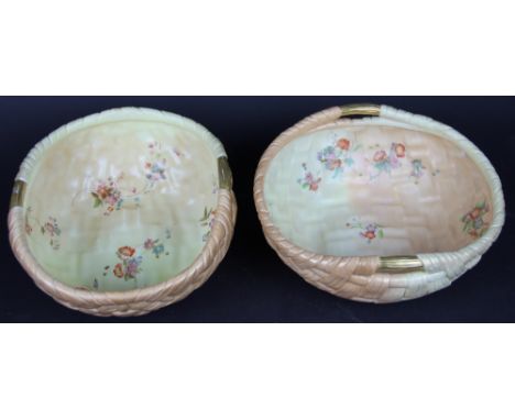 A pair of Graingers Worcester blush ivory baskets, painted with flowers, date code for 1900, 23cm (one restored)