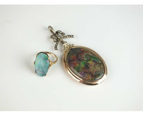 An opal doublet plaque ring, the yellow metal shank not stamped, size L, together with an oval boulder opal pendant, within y