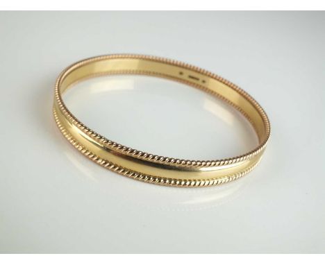 A 9ct gold bangle, with rope twist border, hallmarked Sheffield 1997, weight approx 23.6g