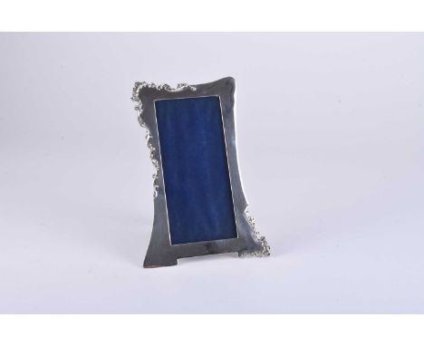 An Edwardian silver mounted photograph frame, Deakin &amp; Francis, Birmingham 1906, of elongated rectangular form with scrol