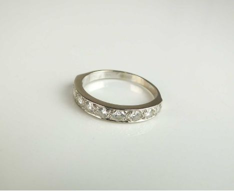 A nine stone diamond ring, the brilliant cut diamonds claw set in white metal to white metal shank, not stamped, ring size R,