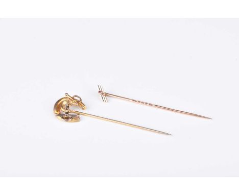 A late 19th century horseshoe stick pin, the reverse stamped 'Gold', together with an Art Deco stick pin, not stamped, total 