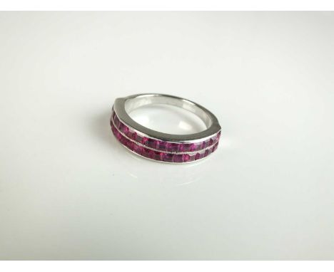 An untested ruby double band half hoop eternity ring, the square cut untested rubies channel set in white metal to white meta