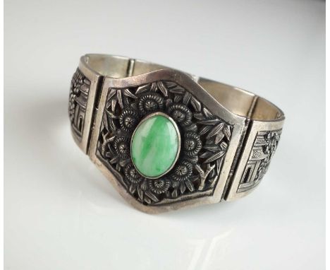 A Chinese white metal jade set bracelet, designed as a central oval cabochon jade plaque set within white metal mount with ba