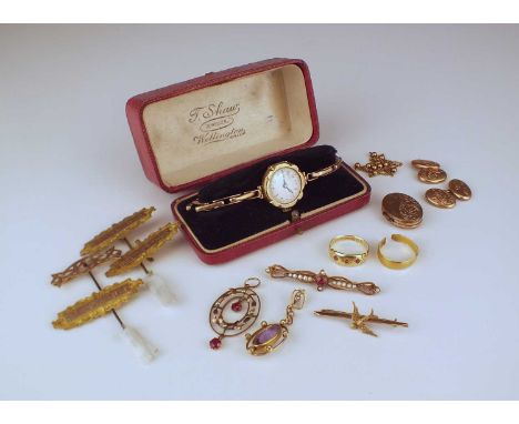 A small collection of jewellery, comprising; a pair of 9ct gold bright cut engraved cufflinks, a garnet and split seed pearl 