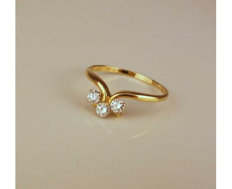 An 18ct gold three stone diamond ring, the three brilliant cut diamonds claw set to yellow gold shank, ring size R, weight ap
