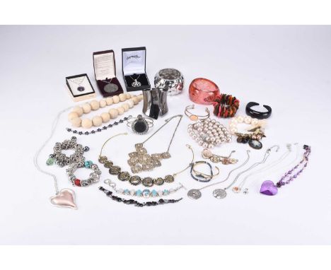 A large collection of various piece of costume jewellery, to include; a white metal bright cut engraved hinged bangle, stampe