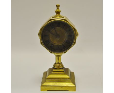 A brass carriage clock, on a plinth base